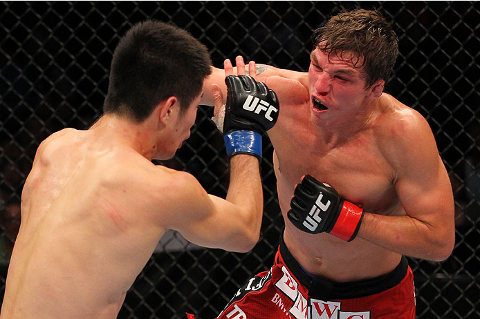 INDIANAPOLIS, IN - AUGUST 28: (R-L) Darren Elkins punches Hatsu Hioki in their featherweight fight during the UFC on FOX Sports 1 event at Bankers Life Fieldhouse on August 28, 2013 in Indianapolis, Indiana. (Photo by Ed Mulholland/Zuffa LLC/Zuffa LLC vi