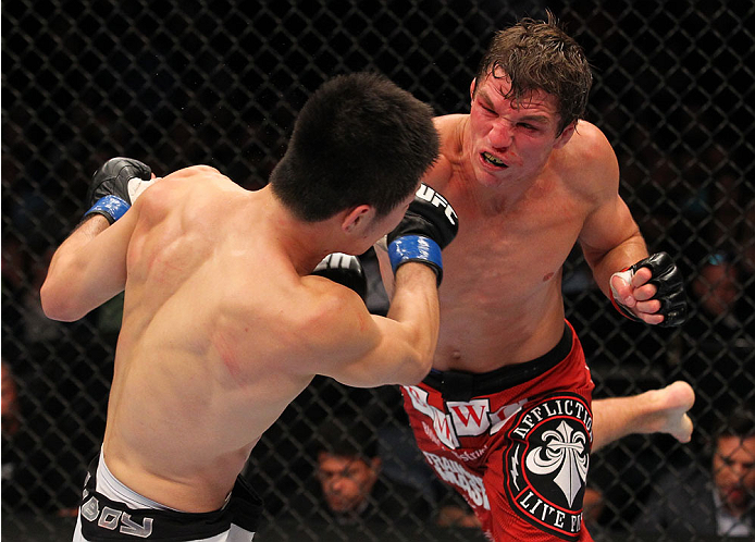 INDIANAPOLIS, IN - AUGUST 28: (R-L) Darren Elkins punches Hatsu Hioki in their featherweight fight during the UFC on FOX Sports 1 event at Bankers Life Fieldhouse on August 28, 2013 in Indianapolis, Indiana. (Photo by Ed Mulholland/Zuffa LLC/Zuffa LLC vi