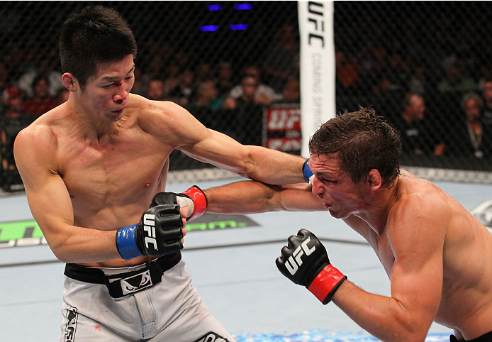 INDIANAPOLIS, IN - AUGUST 28: (L-R) Hatsu Hioki and Darren Elkins trade punches in their featherweight fight during the UFC on FOX Sports 1 event at Bankers Life Fieldhouse on August 28, 2013 in Indianapolis, Indiana. (Photo by Ed Mulholland/Zuffa LLC/Zu