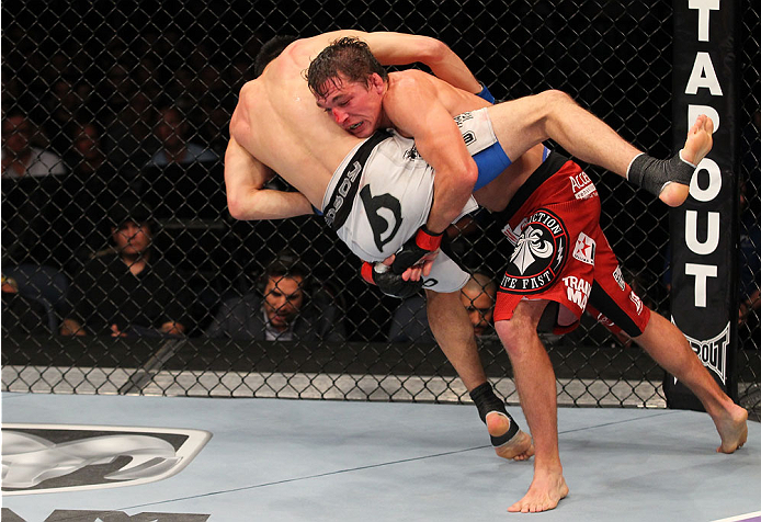 INDIANAPOLIS, IN - AUGUST 28: (R-L) Darren Elkins takes down Hatsu Hioki in their featherweight fight during the UFC on FOX Sports 1 event at Bankers Life Fieldhouse on August 28, 2013 in Indianapolis, Indiana. (Photo by Ed Mulholland/Zuffa LLC/Zuffa LLC