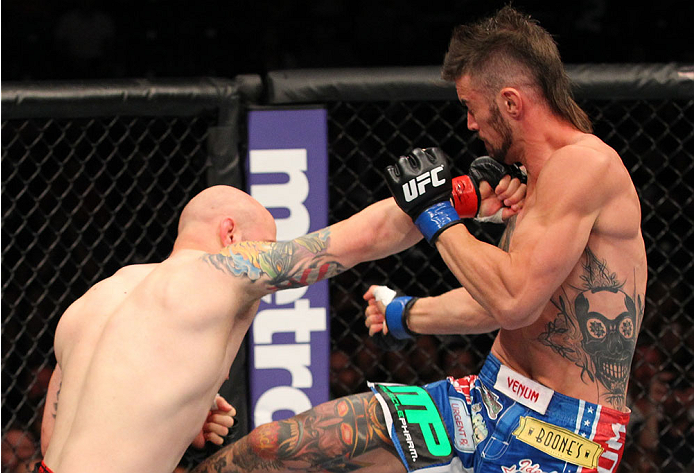 INDIANAPOLIS, IN - AUGUST 28: (L-R) Justin Edwards punches Brandon Thatch in their welterweight fight during the UFC on FOX Sports 1 event at Bankers Life Fieldhouse on August 28, 2013 in Indianapolis, Indiana. (Photo by Ed Mulholland/Zuffa LLC/Zuffa LLC