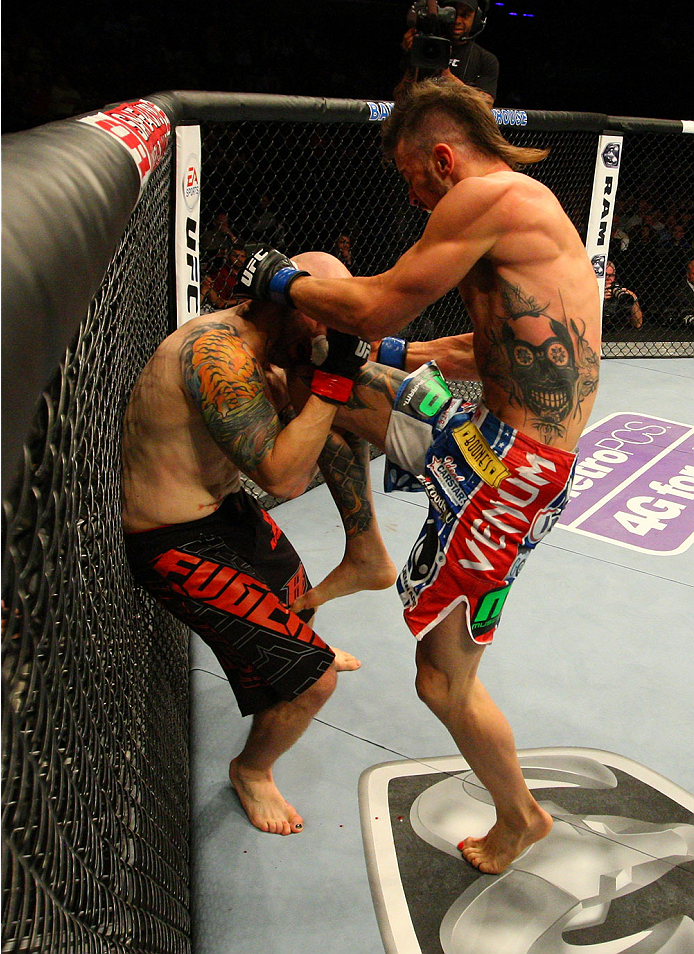 INDIANAPOLIS, IN - AUGUST 28: (R-L) Brandon Thatch knees Justin Edwards in their welterweight fight during the UFC on FOX Sports 1 event at Bankers Life Fieldhouse on August 28, 2013 in Indianapolis, Indiana. (Photo by Ed Mulholland/Zuffa LLC/Zuffa LLC