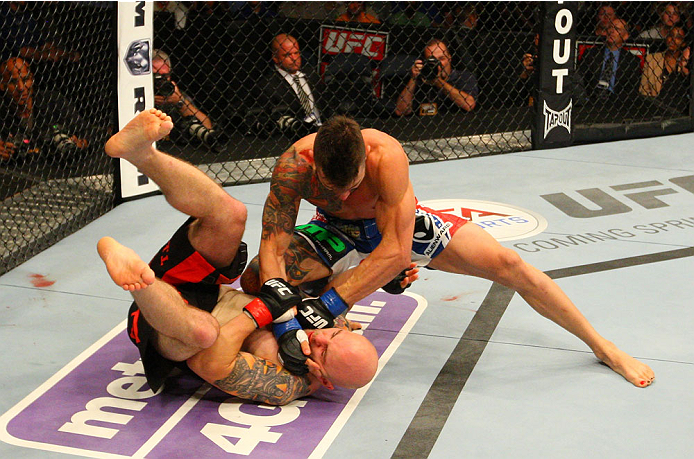 INDIANAPOLIS, IN - AUGUST 28: (R-L) Brandon Thatch punches Justin Edwards in their welterweight fight during the UFC on FOX Sports 1 event at Bankers Life Fieldhouse on August 28, 2013 in Indianapolis, Indiana. (Photo by Ed Mulholland/Zuffa LLC/Zuffa LL