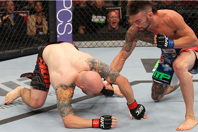 INDIANAPOLIS, IN - AUGUST 28: (R-L) Brandon Thatch punches Justin Edwards in their welterweight fight during the UFC on FOX Sports 1 event at Bankers Life Fieldhouse on August 28, 2013 in Indianapolis, Indiana. (Photo by Ed Mulholland/Zuffa LLC/Zuffa LLC