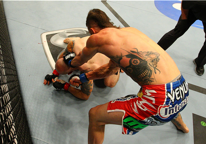 INDIANAPOLIS, IN - AUGUST 28: (R-L) Brandon Thatch punches Justin Edwards in their welterweight fight during the UFC on FOX Sports 1 event at Bankers Life Fieldhouse on August 28, 2013 in Indianapolis, Indiana. (Photo by Ed Mulholland/Zuffa LLC/Zuffa LL