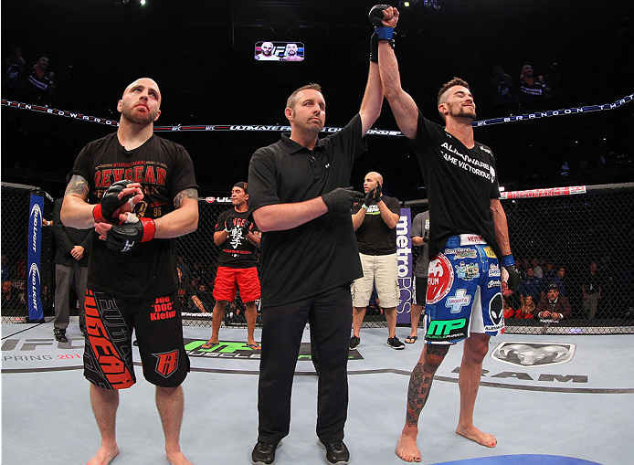 INDIANAPOLIS, IN - AUGUST 28: Brandon Thatch (R) reacts after his knockout victory over Justin Edwards (L) in their welterweight fight during the UFC on FOX Sports 1 event at Bankers Life Fieldhouse on August 28, 2013 in Indianapolis, Indiana. (Photo by