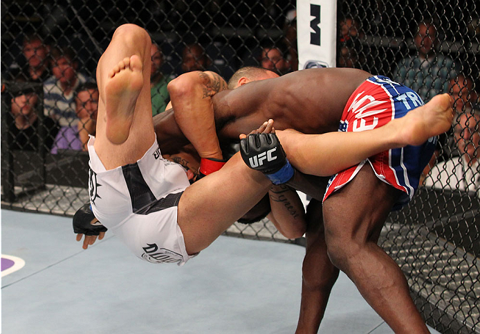 INDIANAPOLIS, IN - AUGUST 28: (R-L) Papy Abedi takes down Dylan Andrews in their middleweight fight during the UFC on FOX Sports 1 event at Bankers Life Fieldhouse on August 28, 2013 in Indianapolis, Indiana. (Photo by Ed Mulholland/Zuffa LLC/Zuffa LLC v