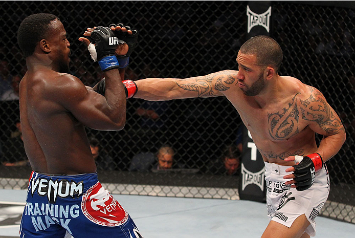 INDIANAPOLIS, IN - AUGUST 28: (R-L) Dylan Andrews punches Papy Abedi in their middleweight fight during the UFC on FOX Sports 1 event at Bankers Life Fieldhouse on August 28, 2013 in Indianapolis, Indiana. (Photo by Ed Mulholland/Zuffa LLC/Zuffa LLC via