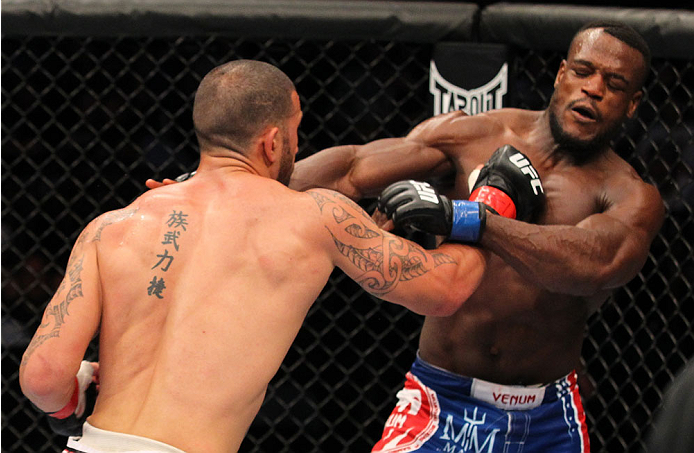 INDIANAPOLIS, IN - AUGUST 28: (L-R) Dylan Andrews punches Papy Abedi in their middleweight fight during the UFC on FOX Sports 1 event at Bankers Life Fieldhouse on August 28, 2013 in Indianapolis, Indiana. (Photo by Ed Mulholland/Zuffa LLC/Zuffa LLC via
