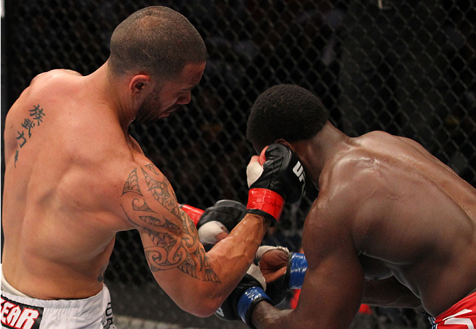 INDIANAPOLIS, IN - AUGUST 28: (L-R) Dylan Andrews punches Papy Abedi in their middleweight fight during the UFC on FOX Sports 1 event at Bankers Life Fieldhouse on August 28, 2013 in Indianapolis, Indiana. (Photo by Ed Mulholland/Zuffa LLC/Zuffa LLC via