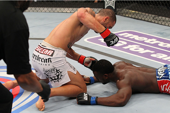 INDIANAPOLIS, IN - AUGUST 28: (L-R) Dylan Andrews punches Papy Abedi in their middleweight fight during the UFC on FOX Sports 1 event at Bankers Life Fieldhouse on August 28, 2013 in Indianapolis, Indiana. (Photo by Ed Mulholland/Zuffa LLC/Zuffa LLC via