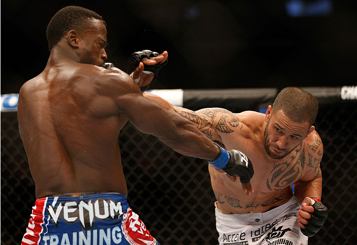 INDIANAPOLIS, IN - AUGUST 28: (R-L) Dylan Andrews punches Papy Abedi in their middleweight fight during the UFC on FOX Sports 1 event at Bankers Life Fieldhouse on August 28, 2013 in Indianapolis, Indiana. (Photo by Josh Hedges/Zuffa LLC/Zuffa LLC via Ge