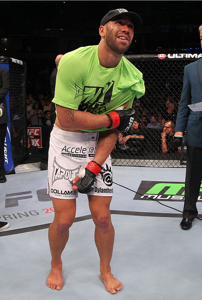 INDIANAPOLIS, IN - AUGUST 28: Dylan Andrews clutches his injured shoulder after knocking out Papy Abedi in their middleweight fight during the UFC on FOX Sports 1 event at Bankers Life Fieldhouse on August 28, 2013 in Indianapolis, Indiana. (Photo by Ed
