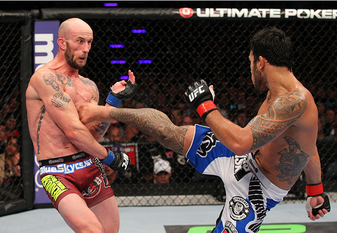 INDIANAPOLIS, IN - AUGUST 28: (R-L) Brad Tavares kicks Bubba McDaniel in their middleweight fight during the UFC on FOX Sports 1 event at Bankers Life Fieldhouse on August 28, 2013 in Indianapolis, Indiana. (Photo by Ed Mulholland/Zuffa LLC/Zuffa LLC via