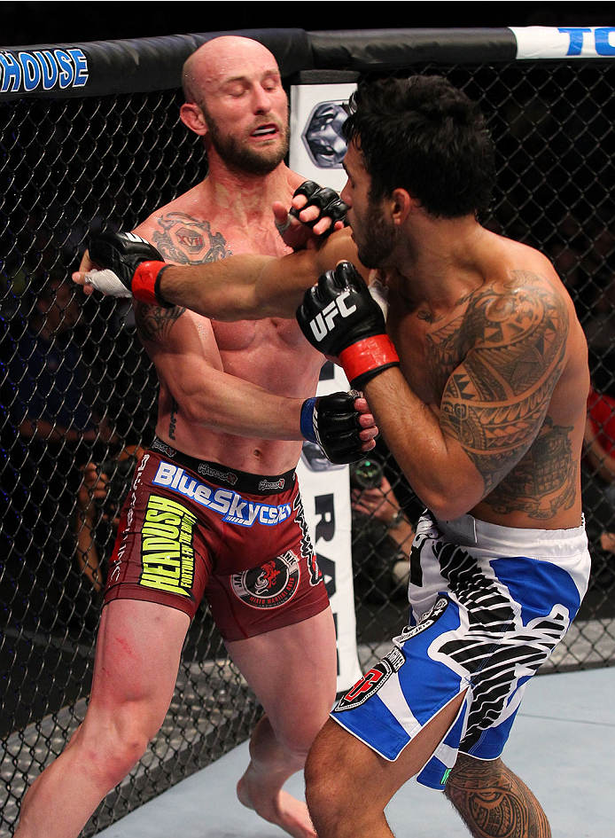 INDIANAPOLIS, IN - AUGUST 28: (R-L) Brad Tavares punches Bubba McDaniel in their middleweight fight during the UFC on FOX Sports 1 event at Bankers Life Fieldhouse on August 28, 2013 in Indianapolis, Indiana. (Photo by Ed Mulholland/Zuffa LLC/Zuffa LLC v