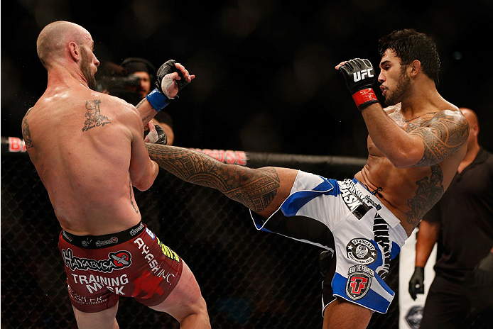 INDIANAPOLIS, IN - AUGUST 28: (R-L) Brad Tavares kicks Bubba McDaniel in their middleweight fight during the UFC on FOX Sports 1 event at Bankers Life Fieldhouse on August 28, 2013 in Indianapolis, Indiana. (Photo by Josh Hedges/Zuffa LLC/Zuffa LLC via G
