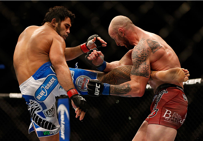 INDIANAPOLIS, IN - AUGUST 28: (L-R) Brad Tavares kicks Bubba McDaniel in their middleweight fight during the UFC on FOX Sports 1 event at Bankers Life Fieldhouse on August 28, 2013 in Indianapolis, Indiana. (Photo by Josh Hedges/Zuffa LLC/Zuffa LLC via G