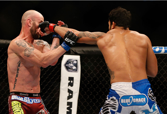 INDIANAPOLIS, IN - AUGUST 28: (R-L) Brad Tavares punches Bubba McDaniel in their middleweight fight during the UFC on FOX Sports 1 event at Bankers Life Fieldhouse on August 28, 2013 in Indianapolis, Indiana. (Photo by Josh Hedges/Zuffa LLC/Zuffa LLC via