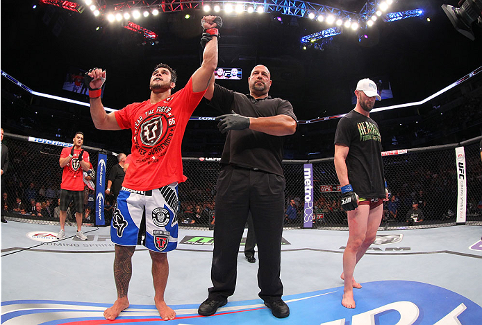 INDIANAPOLIS, IN - AUGUST 28: Brad Tavares (L) reacts after his decision victory over Bubba McDaniel in their middleweight fight during the UFC on FOX Sports 1 event at Bankers Life Fieldhouse on August 28, 2013 in Indianapolis, Indiana. (Photo by Ed Mul