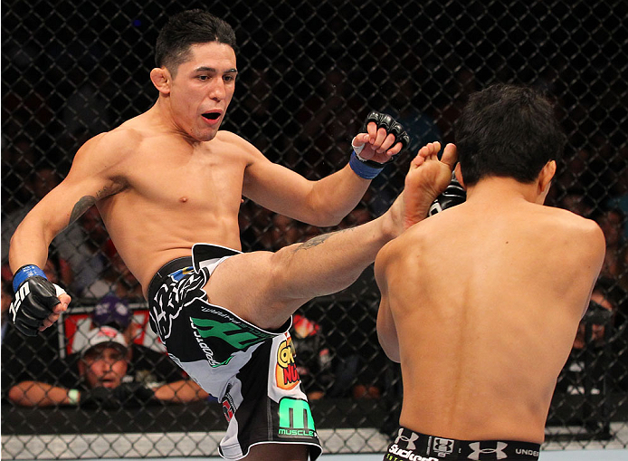 INDIANAPOLIS, IN - AUGUST 28: (L-R) Erik Perez kicks Takeya Mizugaki in their bantamweight fight during the UFC on FOX Sports 1 event at Bankers Life Fieldhouse on August 28, 2013 in Indianapolis, Indiana. (Photo by Ed Mulholland/Zuffa LLC/Zuffa LLC via