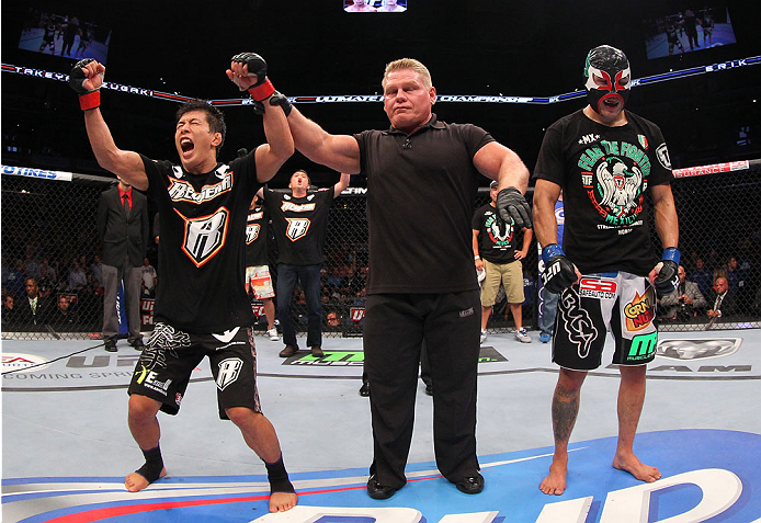 INDIANAPOLIS, IN - AUGUST 28: Takeya Mizugaki (L) reacts after his victory over Erik Perez (R) in their bantamweight fight during the UFC on FOX Sports 1 event at Bankers Life Fieldhouse on August 28, 2013 in Indianapolis, Indiana. (Photo by Ed Mulhollan