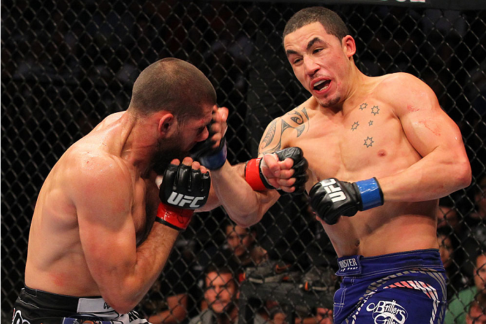 INDIANAPOLIS, IN - AUGUST 28: (R-L) Robert Whittaker punches Court McGee in their welterweight fight during the UFC on FOX Sports 1 event at Bankers Life Fieldhouse on August 28, 2013 in Indianapolis, Indiana. (Photo by Ed Mulholland/Zuffa LLC/Zuffa LLC