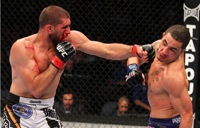 INDIANAPOLIS, IN - AUGUST 28: (L-R) Court McGee punches Robert Whittaker in their welterweight fight during the UFC on FOX Sports 1 event at Bankers Life Fieldhouse on August 28, 2013 in Indianapolis, Indiana. (Photo by Ed Mulholland/Zuffa LLC/Zuffa LLC