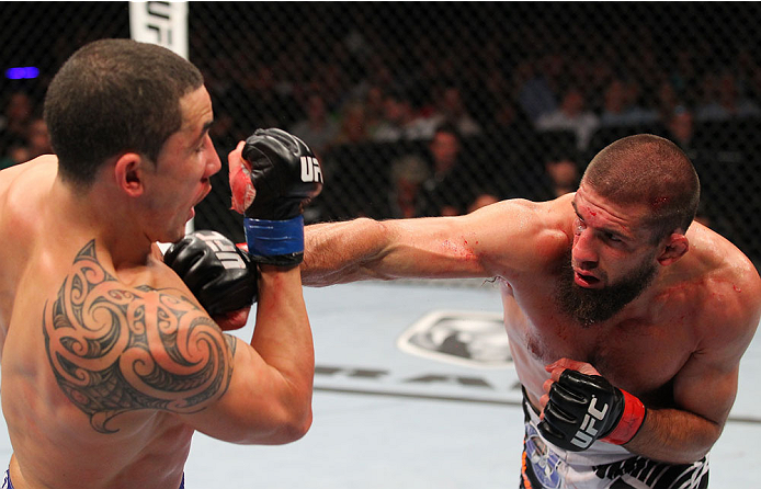 INDIANAPOLIS, IN - AUGUST 28: (R-L) Court McGee punches Robert Whittaker in their welterweight fight during the UFC on FOX Sports 1 event at Bankers Life Fieldhouse on August 28, 2013 in Indianapolis, Indiana. (Photo by Ed Mulholland/Zuffa LLC/Zuffa LLC