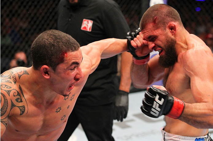 INDIANAPOLIS, IN - AUGUST 28: (L-R) Robert Whittaker punches Court McGee in their welterweight fight during the UFC on FOX Sports 1 event at Bankers Life Fieldhouse on August 28, 2013 in Indianapolis, Indiana. (Photo by Ed Mulholland/Zuffa LLC/Zuffa LLC