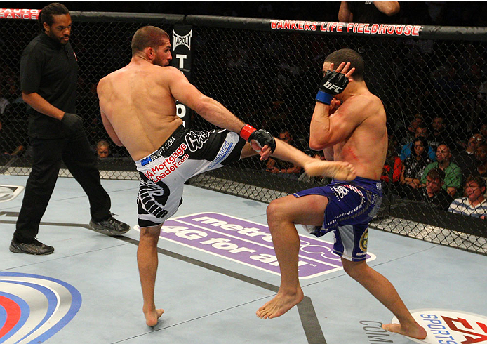 INDIANAPOLIS, IN - AUGUST 28: (L-R) Court McGee kicks Robert Whittaker in their welterweight fight during the UFC on FOX Sports 1 event at Bankers Life Fieldhouse on August 28, 2013 in Indianapolis, Indiana. (Photo by Ed Mulholland/Zuffa LLC/Zuffa LLC vi