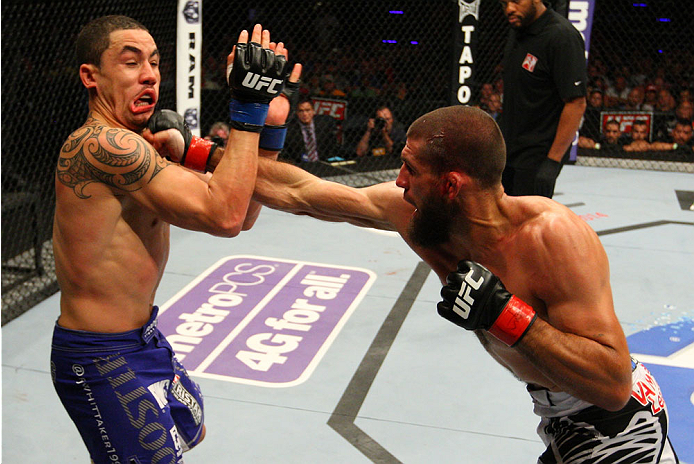 INDIANAPOLIS, IN - AUGUST 28: (R-L) Court McGee punches Robert Whittaker in their welterweight fight during the UFC on FOX Sports 1 event at Bankers Life Fieldhouse on August 28, 2013 in Indianapolis, Indiana. (Photo by Ed Mulholland/Zuffa LLC/Zuffa LLC