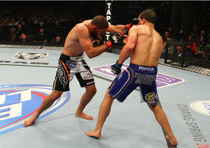 INDIANAPOLIS, IN - AUGUST 28: (L-R) Court McGee punches Robert Whittaker in their welterweight fight during the UFC on FOX Sports 1 event at Bankers Life Fieldhouse on August 28, 2013 in Indianapolis, Indiana. (Photo by Ed Mulholland/Zuffa LLC/Zuffa LLC