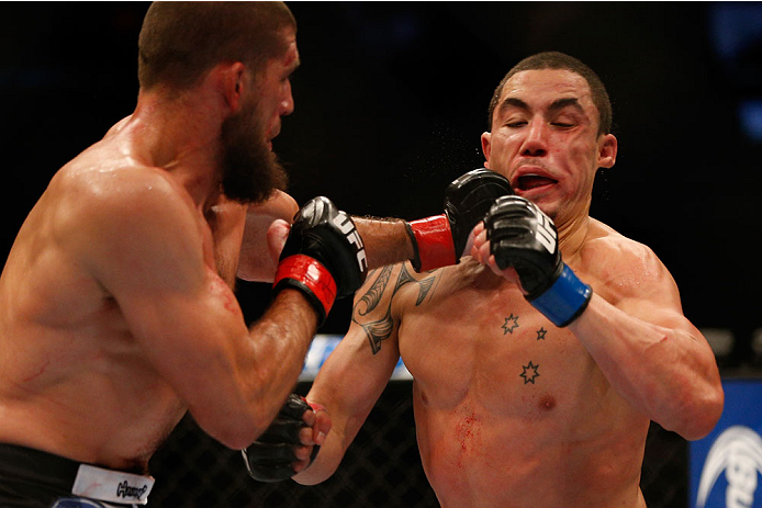 INDIANAPOLIS, IN - AUGUST 28: (L-R) Court McGee punches Robert Whittaker in their welterweight fight during the UFC on FOX Sports 1 event at Bankers Life Fieldhouse on August 28, 2013 in Indianapolis, Indiana. (Photo by Josh Hedges/Zuffa LLC/Zuffa LLC vi