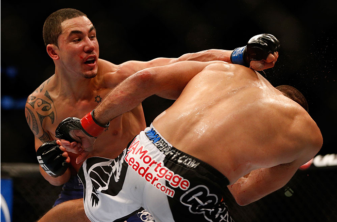 INDIANAPOLIS, IN - AUGUST 28: (R-L) Robert Whittaker punches Court McGee in their welterweight fight during the UFC on FOX Sports 1 event at Bankers Life Fieldhouse on August 28, 2013 in Indianapolis, Indiana. (Photo by Josh Hedges/Zuffa LLC/Zuffa LLC vi
