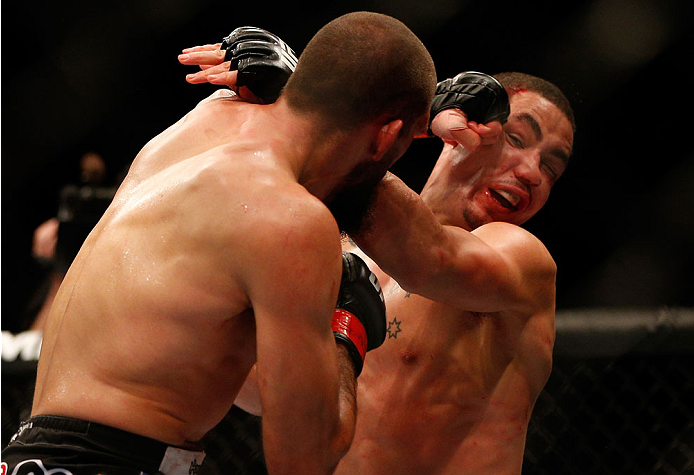INDIANAPOLIS, IN - AUGUST 28: (L-R) Court McGee punches Robert Whittaker in their welterweight fight during the UFC on FOX Sports 1 event at Bankers Life Fieldhouse on August 28, 2013 in Indianapolis, Indiana. (Photo by Josh Hedges/Zuffa LLC/Zuffa LLC vi