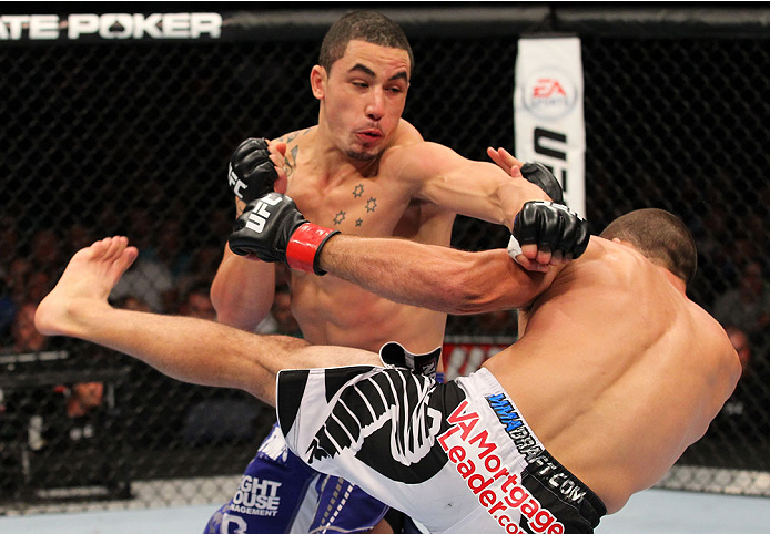 INDIANAPOLIS, IN - AUGUST 28: (L-R) Robert Whittaker punches Court McGee in their welterweight fight during the UFC on FOX Sports 1 event at Bankers Life Fieldhouse on August 28, 2013 in Indianapolis, Indiana. (Photo by Ed Mulholland/Zuffa LLC/Zuffa LLC