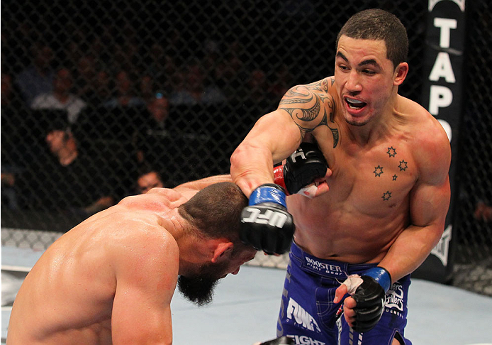 INDIANAPOLIS, IN - AUGUST 28: (R-L) Robert Whittaker punches Court McGee in their welterweight fight during the UFC on FOX Sports 1 event at Bankers Life Fieldhouse on August 28, 2013 in Indianapolis, Indiana. (Photo by Ed Mulholland/Zuffa LLC/Zuffa LLC