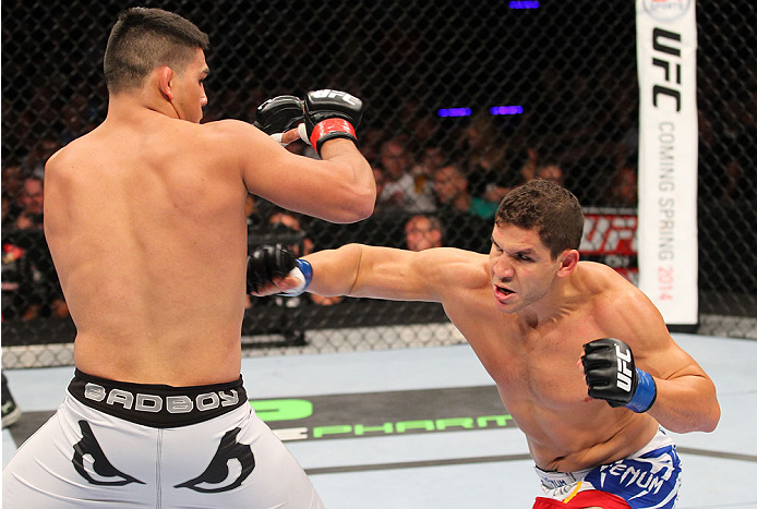 INDIANAPOLIS, IN - AUGUST 28: (R-L) Brian Melancon punches Kelvin Gastelum in their welterweight fight during the UFC on FOX Sports 1 event at Bankers Life Fieldhouse on August 28, 2013 in Indianapolis, Indiana. (Photo by Ed Mulholland/Zuffa LLC/Zuffa LL
