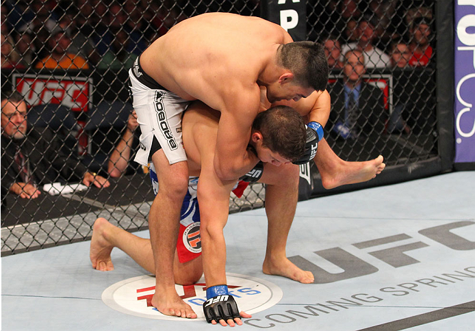 INDIANAPOLIS, IN - AUGUST 28: (L-R) Kelvin Gastelum secures a rear choke submission against Brian Melancon in their welterweight fight during the UFC on FOX Sports 1 event at Bankers Life Fieldhouse on August 28, 2013 in Indianapolis, Indiana. (Photo by