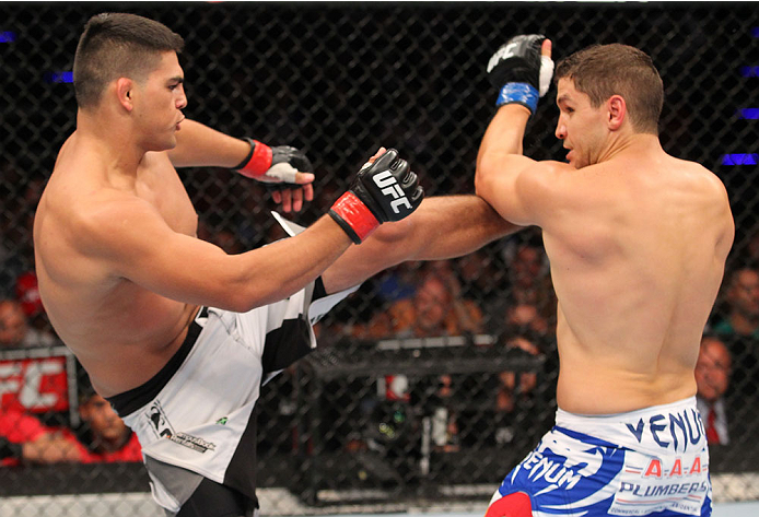 INDIANAPOLIS, IN - AUGUST 28: (L-R) Kelvin Gastelum kicks Brian Melancon in their welterweight fight during the UFC on FOX Sports 1 event at Bankers Life Fieldhouse on August 28, 2013 in Indianapolis, Indiana. (Photo by Ed Mulholland/Zuffa LLC/Zuffa LLC