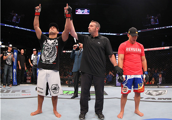INDIANAPOLIS, IN - AUGUST 28: Kelvin Gastelum (L) reacts after his submission victory over Brian Melancon in their welterweight fight during the UFC on FOX Sports 1 event at Bankers Life Fieldhouse on August 28, 2013 in Indianapolis, Indiana. (Photo by E