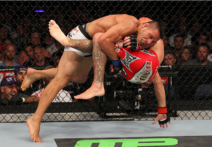 INDIANAPOLIS, IN - AUGUST 28: (L-R) Rafael dos Anjos takes down Donald "Cowboy" Cerrone in their lightweight fight during the UFC on FOX Sports 1 event at Bankers Life Fieldhouse on August 28, 2013 in Indianapolis, Indiana. (Photo by Ed Mulholland/Zuffa