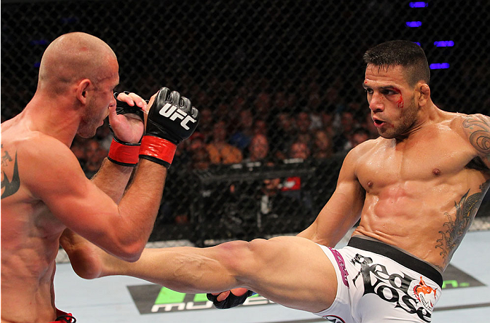 INDIANAPOLIS, IN - AUGUST 28: (R-L) Rafael dos Anjos kicks Donald "Cowboy" Cerrone in their lightweight fight during the UFC on FOX Sports 1 event at Bankers Life Fieldhouse on August 28, 2013 in Indianapolis, Indiana. (Photo by Ed Mulholland/Zuffa LLC/Z