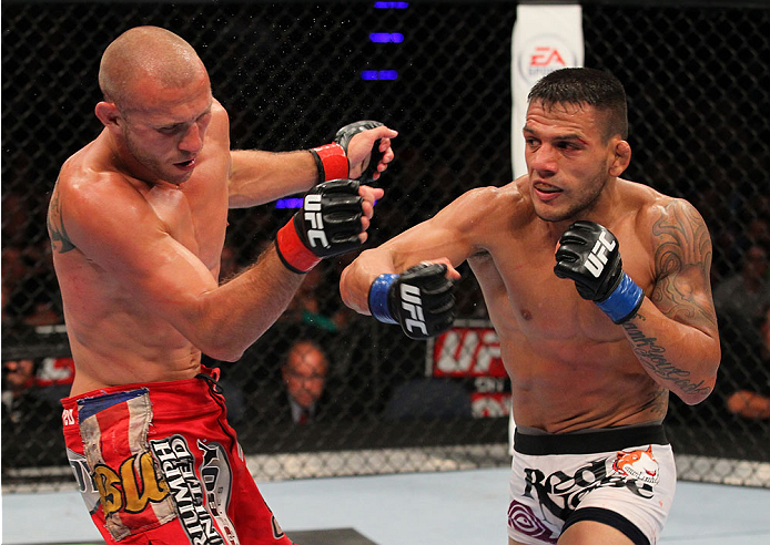 INDIANAPOLIS, IN - AUGUST 28: (R-L) Rafael dos Anjos punches Donald "Cowboy" Cerrone in their lightweight fight during the UFC on FOX Sports 1 event at Bankers Life Fieldhouse on August 28, 2013 in Indianapolis, Indiana. (Photo by Ed Mulholland/Zuffa LLC