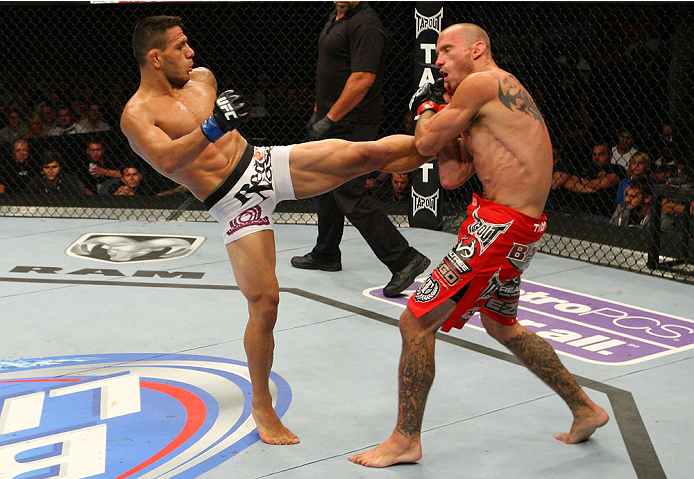 INDIANAPOLIS, IN - AUGUST 28: (L-R) Rafael dos Anjos kicks Donald "Cowboy" Cerrone in their lightweight fight during the UFC on FOX Sports 1 event at Bankers Life Fieldhouse on August 28, 2013 in Indianapolis, Indiana. (Photo by Ed Mulholland/Zuffa LLC/Z