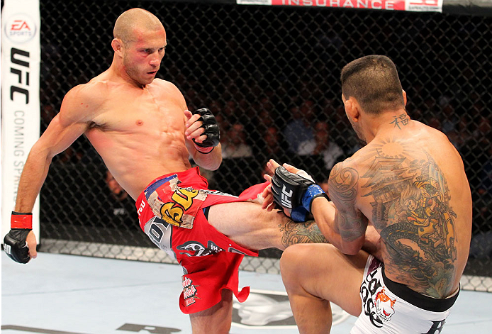 INDIANAPOLIS, IN - AUGUST 28: (L-R) Donald "Cowboy" Cerrone kicks Rafael dos Anjos in their lightweight fight during the UFC on FOX Sports 1 event at Bankers Life Fieldhouse on August 28, 2013 in Indianapolis, Indiana. (Photo by Ed Mulholland/Zuffa LLC/Z