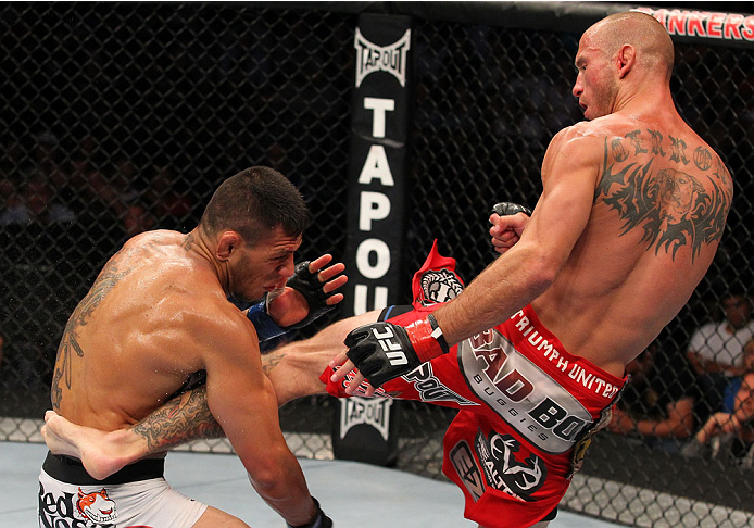 INDIANAPOLIS, IN - AUGUST 28: (R-L) Donald "Cowboy" Cerrone kicks Rafael dos Anjos in their lightweight fight during the UFC on FOX Sports 1 event at Bankers Life Fieldhouse on August 28, 2013 in Indianapolis, Indiana. (Photo by Ed Mulholland/Zuffa LLC/Z