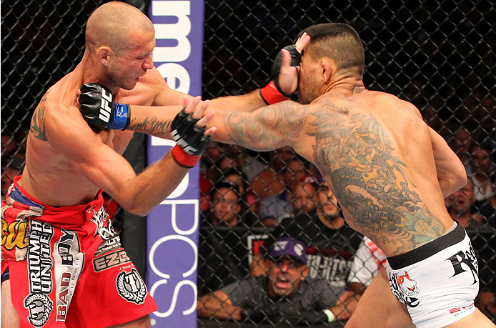 INDIANAPOLIS, IN - AUGUST 28: (R-L) Rafael dos Anjos punches Donald "Cowboy" Cerrone in their lightweight fight during the UFC on FOX Sports 1 event at Bankers Life Fieldhouse on August 28, 2013 in Indianapolis, Indiana. (Photo by Ed Mulholland/Zuffa LLC