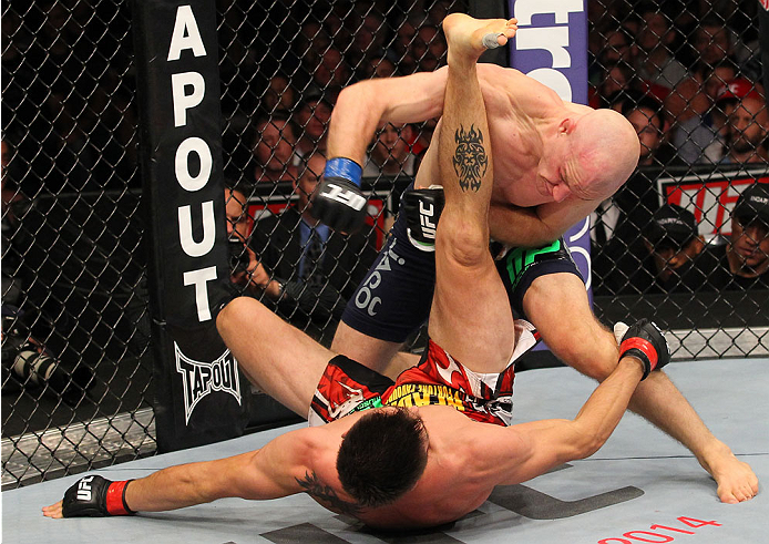 INDIANAPOLIS, IN - AUGUST 28: Martin Kampmann (top) punches Carlos Condit in their welterweight fight during the UFC on FOX Sports 1 event at Bankers Life Fieldhouse on August 28, 2013 in Indianapolis, Indiana. (Photo by Ed Mulholland/Zuffa LLC/Zuffa LLC