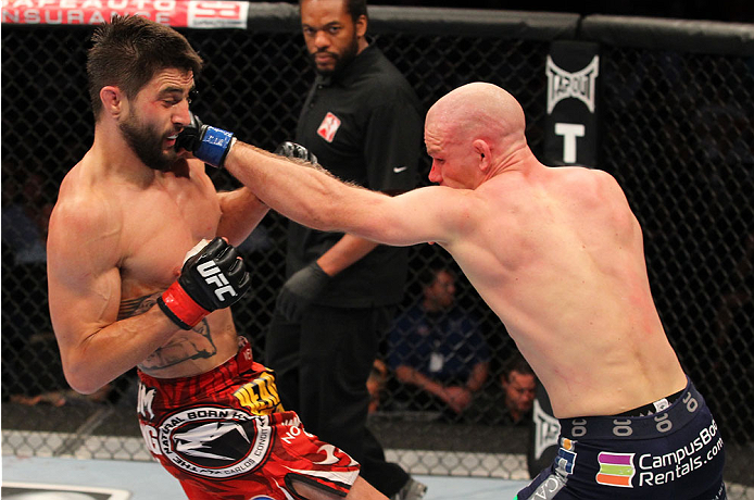 INDIANAPOLIS, IN - AUGUST 28: (R-L) Martin Kampmann punches Carlos Condit in their welterweight fight during the UFC on FOX Sports 1 event at Bankers Life Fieldhouse on August 28, 2013 in Indianapolis, Indiana. (Photo by Ed Mulholland/Zuffa LLC/Zuffa LLC